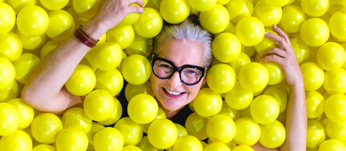 Smiling Senior In Yellow Ball Pit